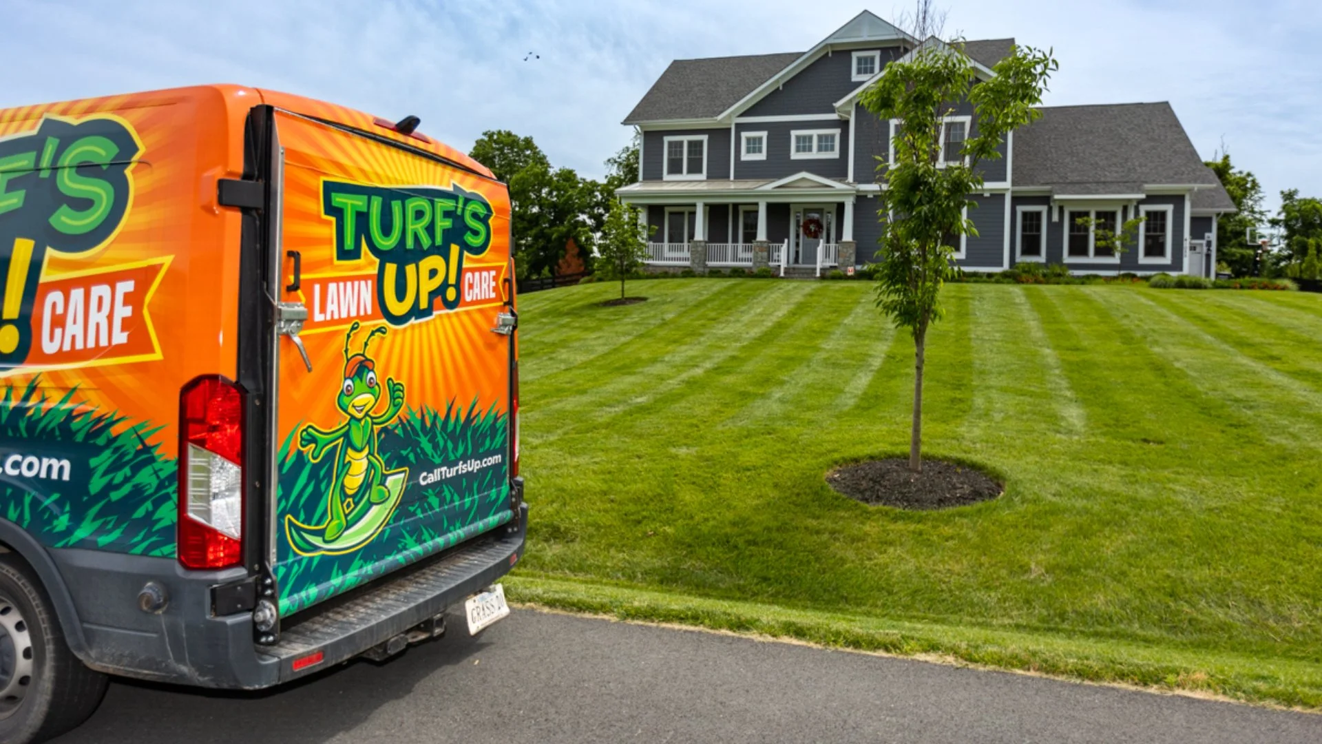 Turf's Up Lawn Care truck at customer's home.