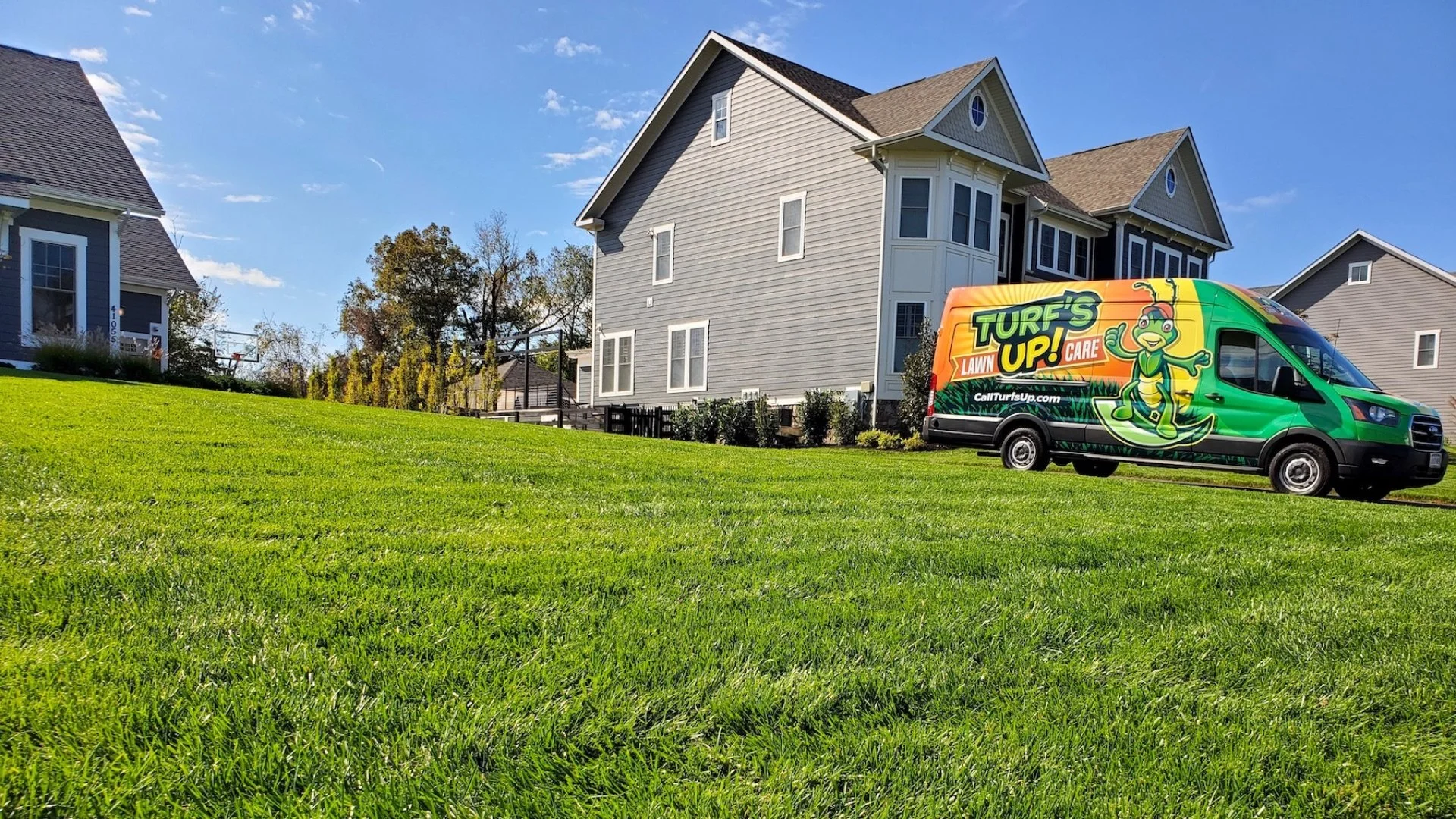 Turf's Up Lawn Care truck at customer's property.
