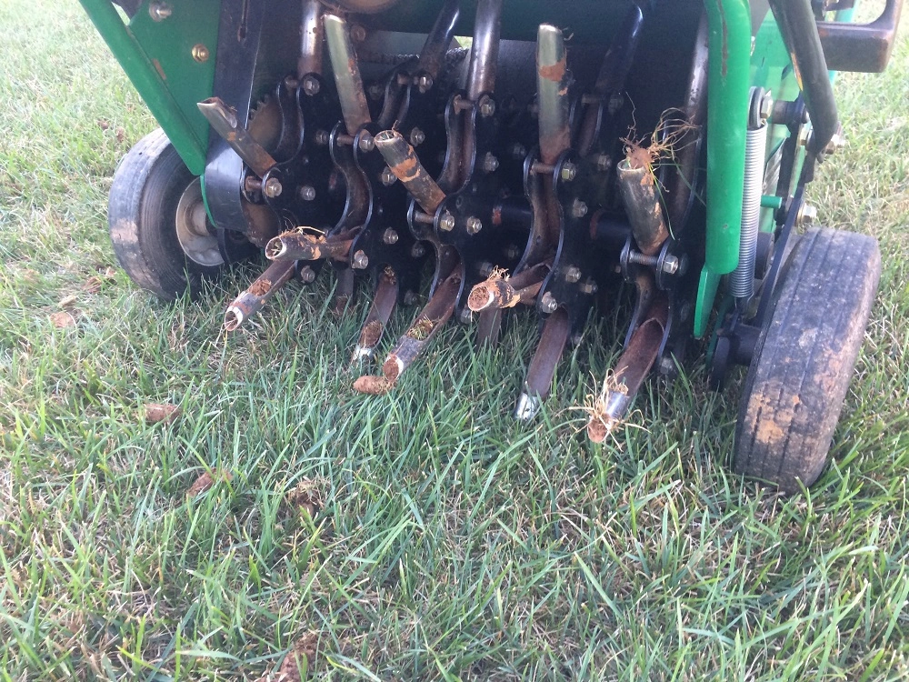 aeration machine punches holes in grass