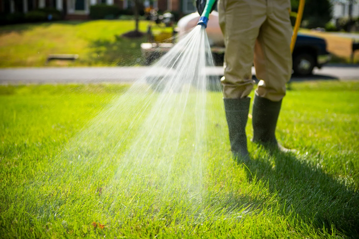 lawn care crew sprays turf for disease