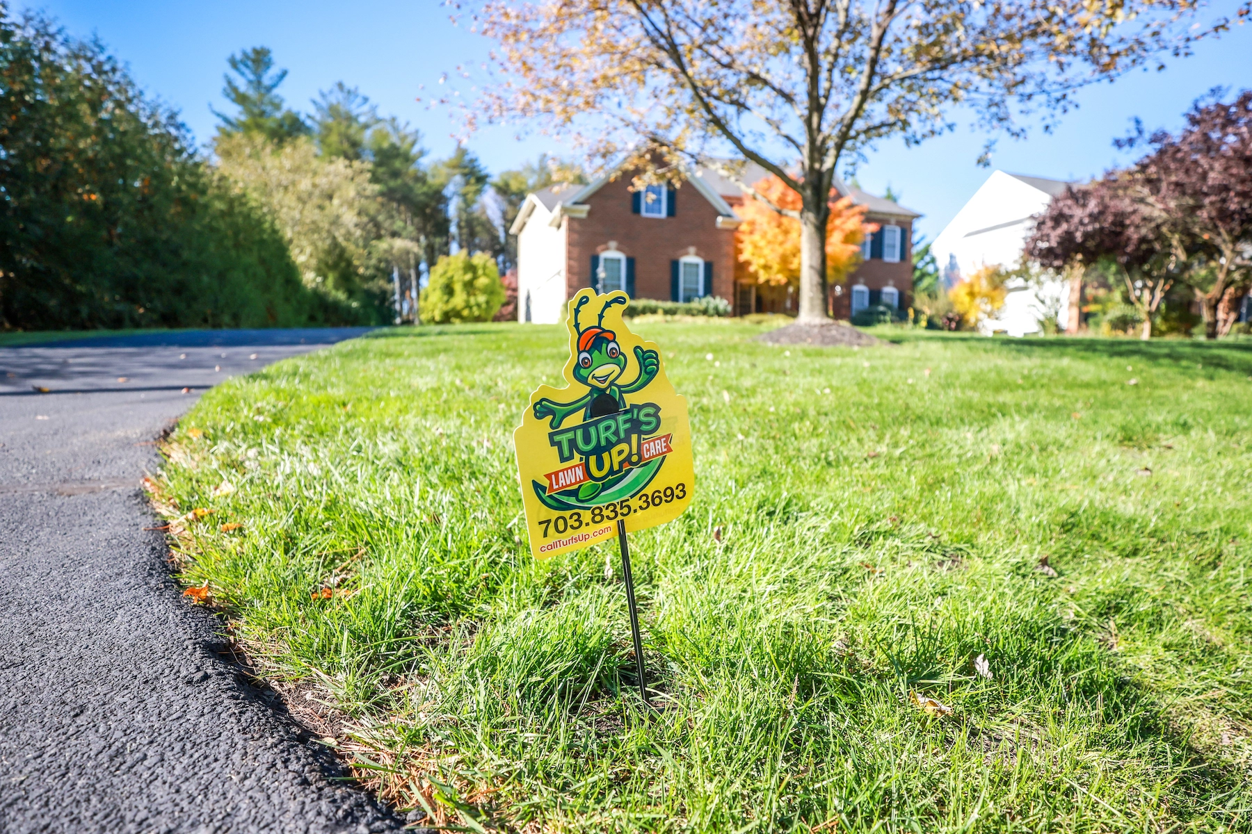 lawn care sign in grass during fall