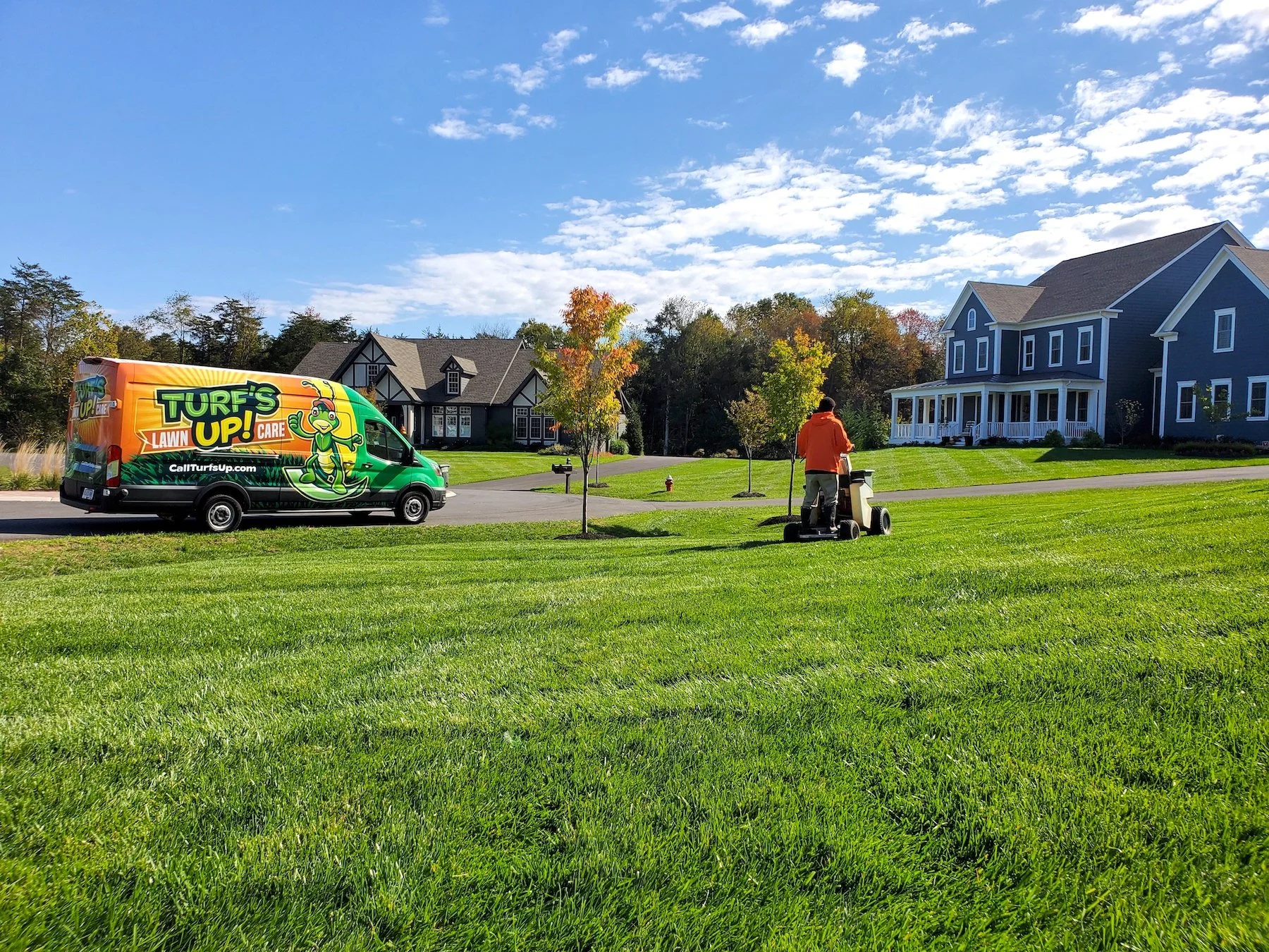 lawn care technician fertilizes yard